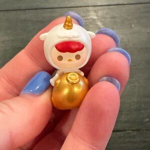 Pucky Shining Gold figure from the POP BEAN Lucky Charm series by POP MART